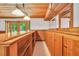 Charming home bar with wood accents, ample counter space, overhead lighting, and convenient access to the backyard at 280 W Knight W Rd, Mcdonough, GA 30252