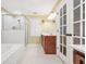 Bright bathroom featuring a soaking tub and a glass-door walk-in shower with classic fixtures and finishes at 280 W Knight W Rd, Mcdonough, GA 30252