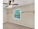 Bright room featuring a ceiling fan and a view to the green outdoors with floating shelves for storage at 280 W Knight W Rd, Mcdonough, GA 30252