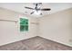 Bright room featuring a ceiling fan and a view to the green outdoors with floating shelves for storage at 280 W Knight W Rd, Mcdonough, GA 30252