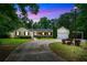 Charming single-story home with lush landscaping, a curved driveway, and a two-car garage and car port at 280 W Knight W Rd, Mcdonough, GA 30252
