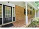 Charming front porch with brick flooring and columns, enhancing the curb appeal of this lovely home at 280 W Knight W Rd, Mcdonough, GA 30252