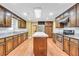 Bright and airy kitchen with wooden cabinets, granite counters, an island, and modern stainless steel appliances at 280 W Knight W Rd, Mcdonough, GA 30252