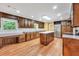 Spacious kitchen featuring wooden cabinets, granite countertops, a central island, and stainless steel appliances at 280 W Knight W Rd, Mcdonough, GA 30252