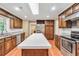 Modern kitchen with wooden cabinets, granite countertops, a large island, and stainless steel appliances for gourmet cooking at 280 W Knight W Rd, Mcdonough, GA 30252