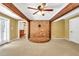 Living room featuring exposed wood beams, a brick accent wall, and access to the backyard at 280 W Knight W Rd, Mcdonough, GA 30252