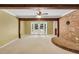 Bright living room with a brick accent wall, a ceiling fan, and French doors to a patio at 280 W Knight W Rd, Mcdonough, GA 30252