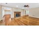 Cozy living room with a traditional fireplace and hardwood flooring at 280 W Knight W Rd, Mcdonough, GA 30252