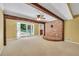 Bright living room with a brick accent wall, a ceiling fan, and French doors to a patio at 280 W Knight W Rd, Mcdonough, GA 30252