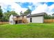 Newly renovated home with a sprawling backyard, complete with a wooden deck and a well-manicured lawn at 932 Brian Ln, Forest Park, GA 30297
