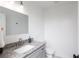 Modern bathroom boasts a granite countertop, decorative faucet, framed mirror and updated fixtures creating a luxurious space at 932 Brian Ln, Forest Park, GA 30297