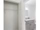En-suite bath with granite counters, updated cabinetry, stylish fixtures, and an adjacent walk-in closet for added convenience at 932 Brian Ln, Forest Park, GA 30297