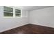 This bedroom is bright and airy with natural light and dark hardwood floors at 932 Brian Ln, Forest Park, GA 30297