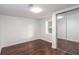 This bedroom has a clean and modern aesthetic with hardwood floors and a mirrored closet at 932 Brian Ln, Forest Park, GA 30297