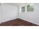 The bedroom is brightly lit from dual windows, and the space boasts refinished hardwood floors at 932 Brian Ln, Forest Park, GA 30297
