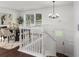 Bright dining area featuring a staircase, stylish chandelier, and modern decor at 932 Brian Ln, Forest Park, GA 30297