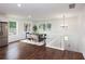 Bright dining area with dark wood floors, stylish table, and stairway to basement at 932 Brian Ln, Forest Park, GA 30297