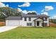 Charming two-story home with a lush green lawn and a spacious two-car garage at 932 Brian Ln, Forest Park, GA 30297