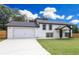 Charming two-story home with a lush green lawn and a spacious two-car garage at 932 Brian Ln, Forest Park, GA 30297