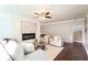 Beautifully staged living room with fireplace, hardwood floors, and abundant natural light at 932 Brian Ln, Forest Park, GA 30297