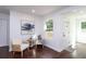 Cozy living room features stylish hardwood floors, white walls and comfortable seating near bright windows at 932 Brian Ln, Forest Park, GA 30297