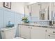 Charming bathroom featuring blue wainscoting, a white vanity, and a granite countertop at 2471 Cedar W Brk, Marietta, GA 30067