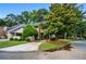 Charming exterior of a home with a well-maintained lawn, mature trees, and inviting curb appeal at 2471 Cedar W Brk, Marietta, GA 30067