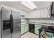 Well-equipped kitchen with stainless steel refrigerator, white cabinets, and modern appliances at 2471 Cedar W Brk, Marietta, GA 30067