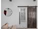 View of en suite bathroom through an open barn door, featuring marble shower at 2850 Stonehall Se Ct, Smyrna, GA 30080