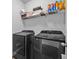 Laundry room featuring a side-by-side washer and dryer with shelving and laundry supplies at 2850 Stonehall Se Ct, Smyrna, GA 30080