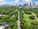 Stunning aerial view showcases the Atlanta skyline over lush green trees and a long road at 411 10Th Ne St # 6, Atlanta, GA 30309