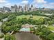 Incredible aerial view captures a serene lake, lush park, and Atlanta skyline backdrop at 411 10Th Ne St # 6, Atlanta, GA 30309
