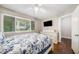 Bright bedroom with a ceiling fan, large window, hardwood floors, and a white dresser with mounted TV at 411 10Th Ne St # 6, Atlanta, GA 30309