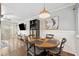 Bright dining area with wood floors, round table, modern light fixture and stylish decorations at 411 10Th Ne St # 6, Atlanta, GA 30309