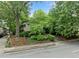 Exterior view of a multi-Gathering home showcasing mature trees, professional landscaping, and concrete sidewalks at 411 10Th Ne St # 6, Atlanta, GA 30309