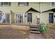 Two-story olive green building with stairs leading to a porch and an entrance at 411 10Th Ne St # 6, Atlanta, GA 30309