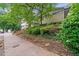 Exterior view of a multi-Gathering home featuring a brick base, manicured landscaping, and a sign at 411 10Th Ne St # 6, Atlanta, GA 30309