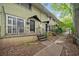 Two-story olive green building with small porches and stairs, set amongst trees at 411 10Th Ne St # 6, Atlanta, GA 30309