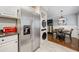 Kitchen and dining area combination with white cabinets, stainless appliances, and hardwood floors at 411 10Th Ne St # 6, Atlanta, GA 30309