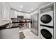 Modern kitchen featuring stainless steel appliances, granite countertops, white cabinets, plus a washer/dryer combo at 411 10Th Ne St # 6, Atlanta, GA 30309