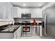 Modern kitchen featuring stainless steel appliances, granite countertops, and white cabinetry at 411 10Th Ne St # 6, Atlanta, GA 30309