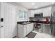 Well-lit kitchen featuring stainless steel appliances, granite countertops, and classic white cabinetry at 411 10Th Ne St # 6, Atlanta, GA 30309