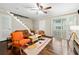 Bright living room featuring hardwood floors, staircase, sliding doors, and modern furnishings at 411 10Th Ne St # 6, Atlanta, GA 30309