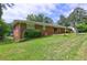 Brick home's backyard features a large lawn and mature trees at 5739 Cobb Mdw, Norcross, GA 30093