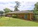 Brick home's backyard features a large lawn and mature trees at 5739 Cobb Mdw, Norcross, GA 30093