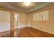 Bright bedroom featuring hardwood floors, a window, and closet, offering comfort and functionality at 5739 Cobb Mdw, Norcross, GA 30093