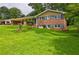 Charming brick home featuring a lush green lawn, covered parking, and inviting curb appeal at 5739 Cobb Mdw, Norcross, GA 30093