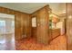 Retro kitchen area with wood paneled walls, wood cabinets, linoleum floors, and standard appliances at 5739 Cobb Mdw, Norcross, GA 30093