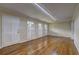 Spacious living room with hardwood floors, white trim, and ample natural light from three large windows at 5739 Cobb Mdw, Norcross, GA 30093