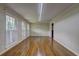 Spacious living room with hardwood floors, white trim, and ample natural light from three large windows at 5739 Cobb Mdw, Norcross, GA 30093